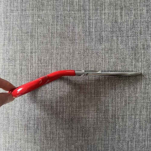 wall upholstery scissors has a bent handle in red color